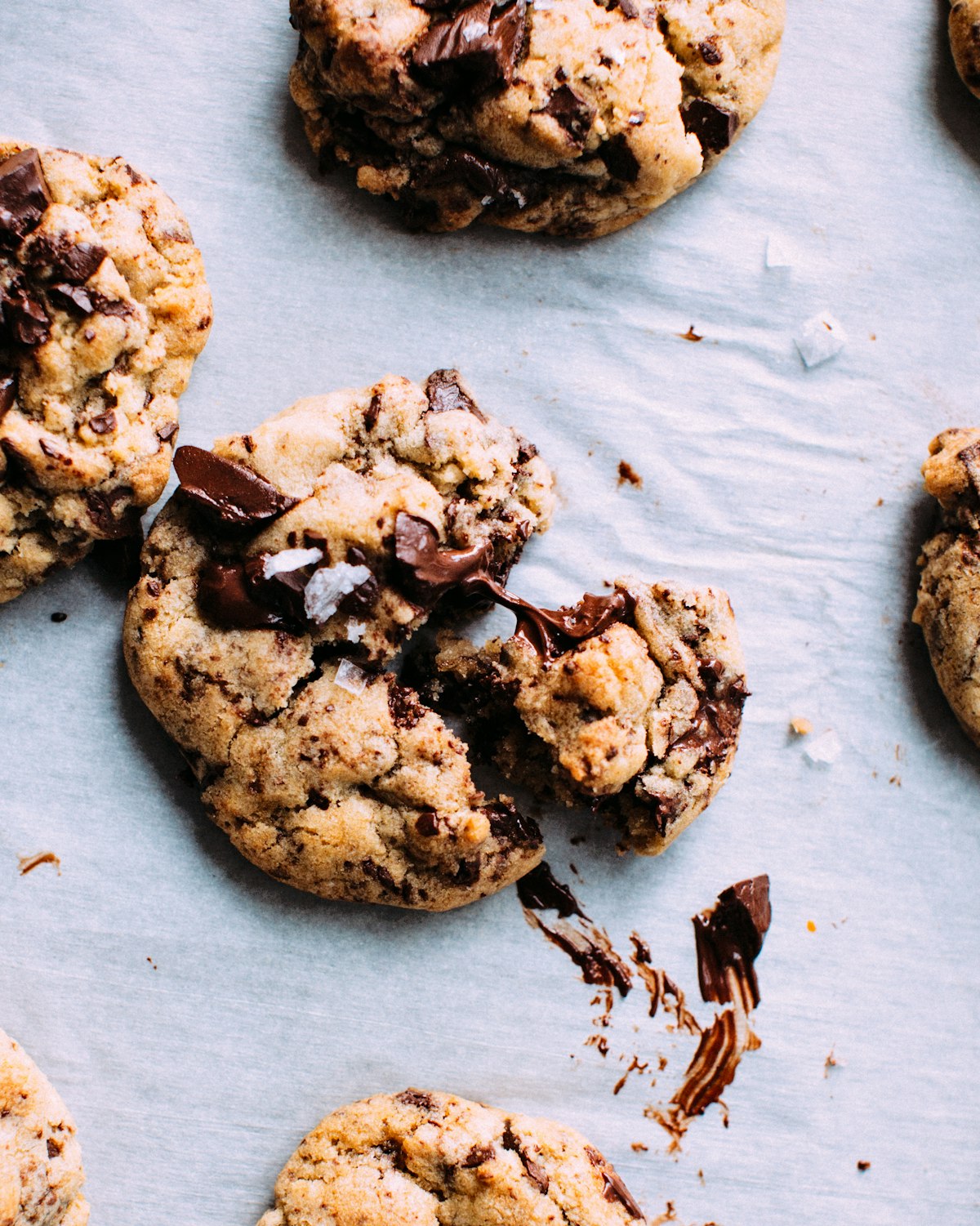 Freshly baked chocolate chip cookies arranged on a baking tray