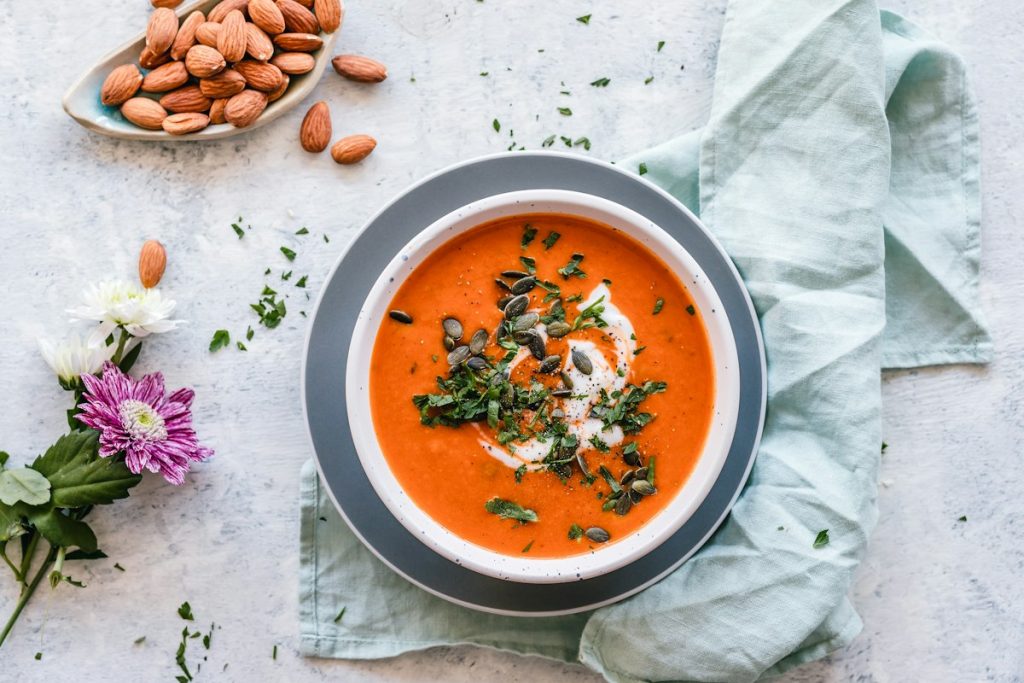 Bowl of homemade soup served with fresh herbs