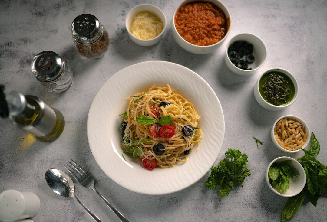 Pasta with tomatoes and olives in a bowl