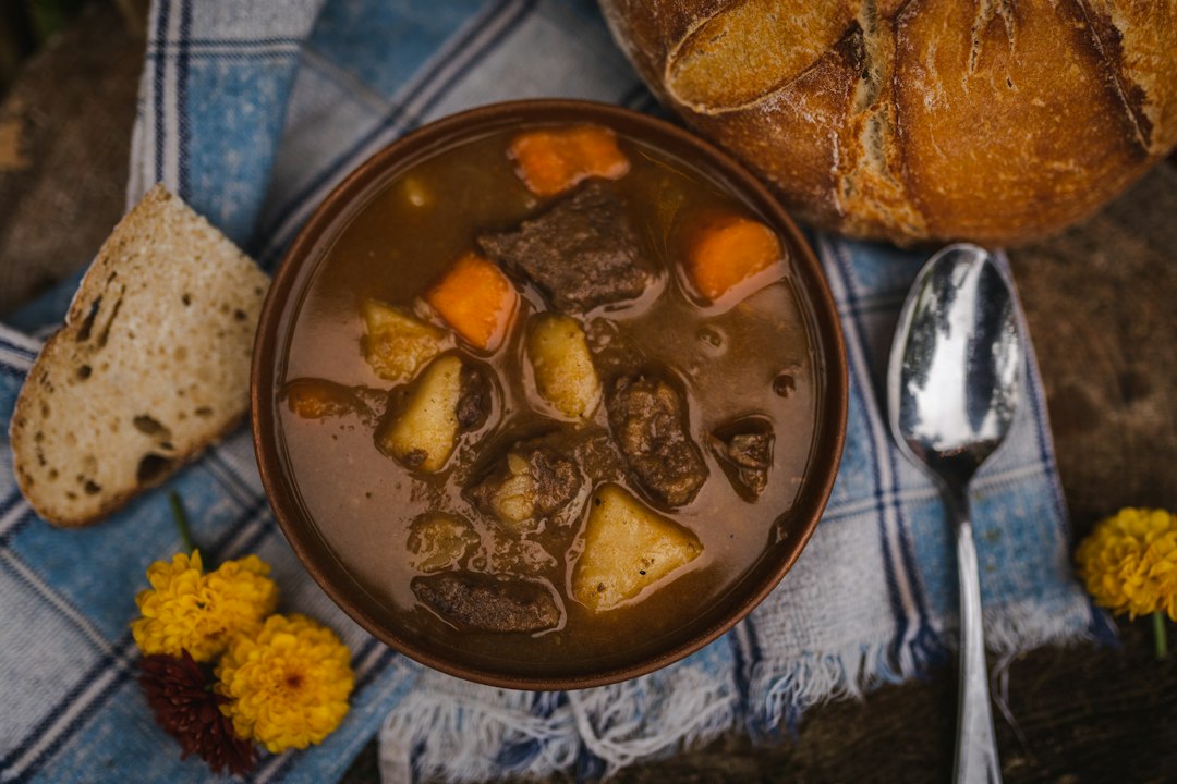 Beef stew and bread on a dining table